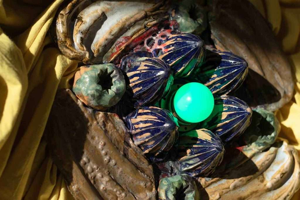 Laura Aldridge, 'The Inside of Aliveness', glazed stoneware, plant dyed fabric (weld and indigo), green bulb, wood, lighting components, courtesy of the artist and Kendall Koppe, Glasgow.